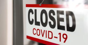 Coronavirus-showing-closed-businesses-for-COVID-19-sign-on--store-window